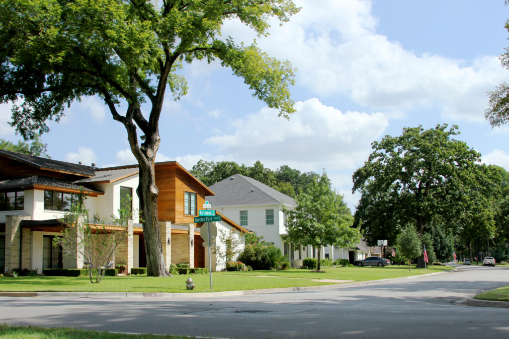 Single-story 1950s ranch home under mature trees in Tanglewood, Fort Worth