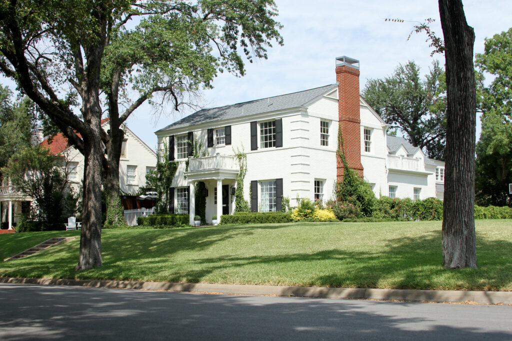 Two-story Colonial-style home with mature trees in the Colonial neighborhood of Fort Worth, Texas