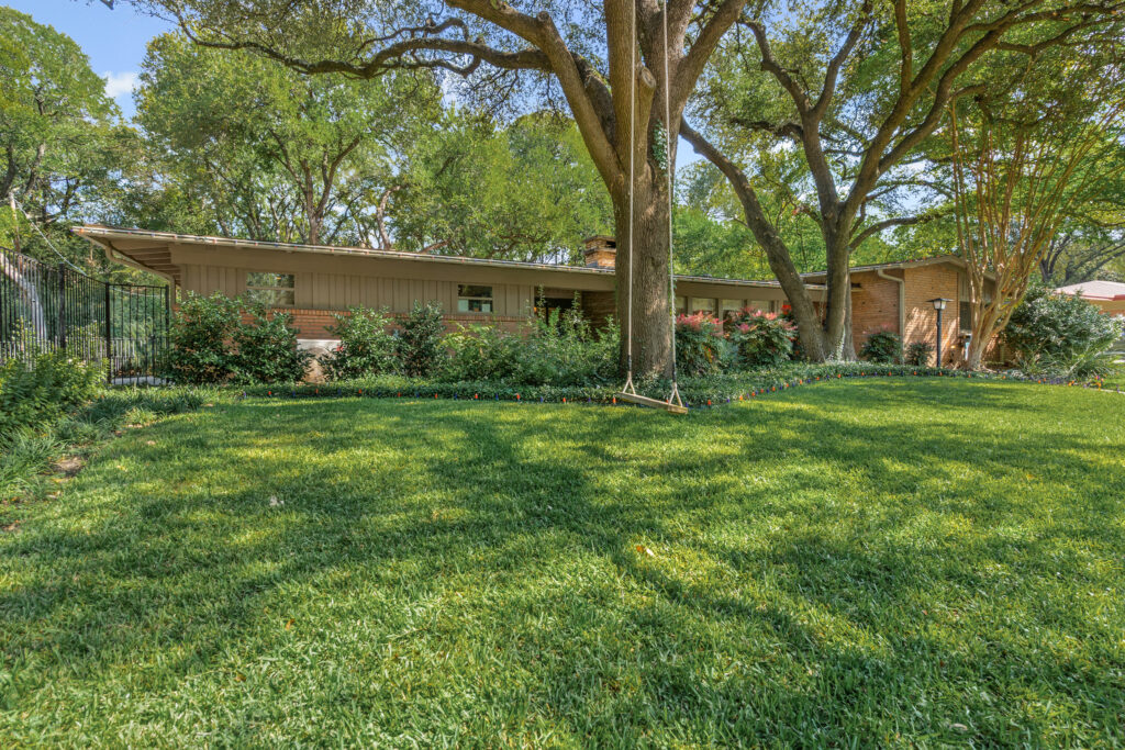 Mid-century modern home with wood and glass facade in Overton Park, Fort Worth, Texas
